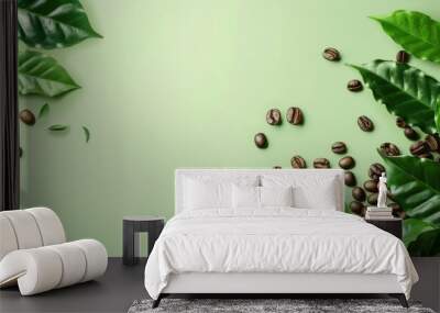 coffee leaves and beans on light green background, flat lay. Space for text Wall mural