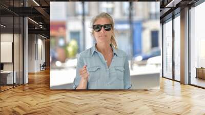 Portrait of an attractive middle age urban woman wearing sunglasses. Wall mural