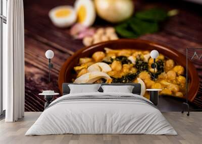 Delicious and traditional dish of chickpea stew with spinach and egg Wall mural