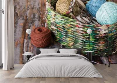 Accessories for knitting.   Basket with accessories for knitting and  crochet hooks on the old wooden table. Wall mural