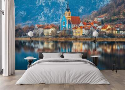 Durnstein, Austria, a picturesque village, is a gem in the Wachau Valley. The azure church stands out, its reflection shimmering in the tranquil Danube River. Wall mural