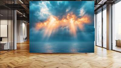 A beautiful blue sky with sun rays illuminating the clouds from behind. Wall mural