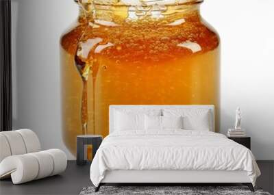 A jar  of golden honey on white background. Generative AI.  Wall mural