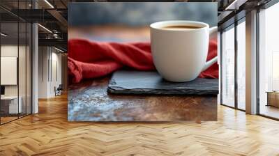 A white coffee mug on a piece of gray slate with a red linen cloth napkin behind it.  Wall mural