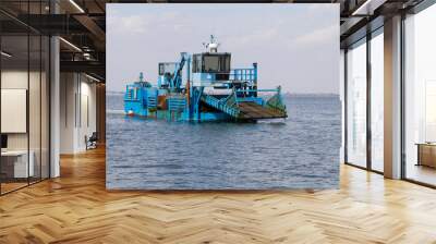 Close up of a blue dredger working on italian Po river lagoon. Industrial vehicle Wall mural