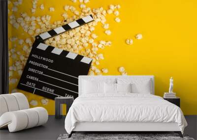 Movie clapperboard and popcorn on a yellow background as a concept for movies with space for copy Wall mural