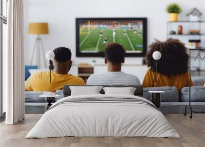 Happy african american football fans cheering team. Exited people watch super bowl game. Fun soccer match. Friends support players at home. Tv broadcast. Cozy interior. Wall mural