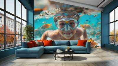 Little boy dives deep under water with blue mask, looks at underwater world. Beautiful young kid diver swim at ocean. Extreme sport activity concept. Sea depth snorkeling. Fun adventure outdoor. Wall mural