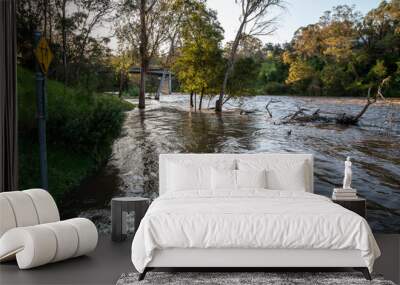 The Yarra River breaks its banks and floods the riverside path at Warrandyte River Reserve. Floods near Melbourne at Warrandyte, Victoria, Australia. 8 October 2023. Wall mural