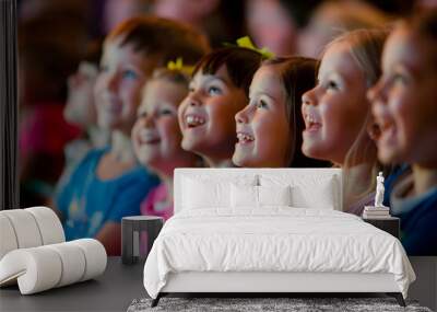 Side view of children audience enjoying a kids concert or movie with happy smiling faces. Wall mural