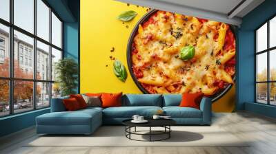 A delicious pasta dish, baked in a casserole with a rich tomato sauce and melted cheese, sits on a bright yellow background. Wall mural