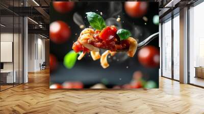 A forkful of pasta with tomato sauce and fresh basil.  The image shows tomatoes and basil floating in the air around the fork. Wall mural