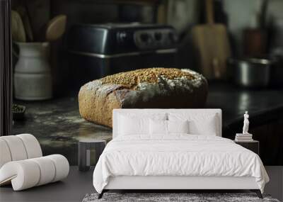 A loaf of lentil bread sits on a dark kitchen counter, ready for the Christmas feast. Wall mural