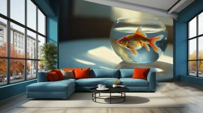 A tiny, colorful goldfish swims in a round glass bowl. The bowl sits on a white table inside. There's room to write something next to it. Wall mural