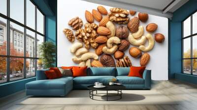 A variety of nuts, such as almonds, walnuts, and cashews, are scattered on a plain white surface. Wall mural