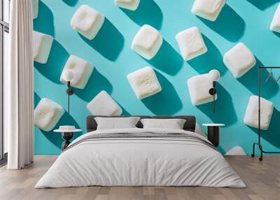 Soft, white marshmallows arranged on a blue background. The image has a colorful, artistic feel. Wall mural