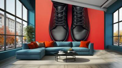 Stylish black shoes for teens, made from real leather. They look great against a red backdrop. Wall mural