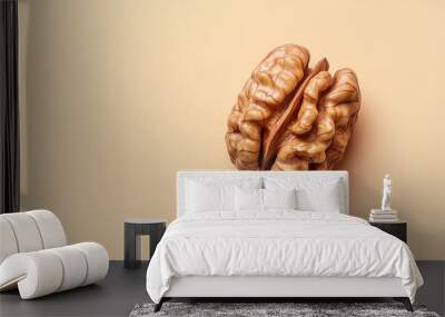 A detailed closeup captures a single walnut nestled on a solid pastel background, highlighting its intricate texture and unique shell features. The composition emphasizes simplicity and elegance Wall mural