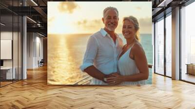 A happy retired couple stands on the deck of a cruise ship, smiling at each other as the sun sets over the ocean horizon Wall mural