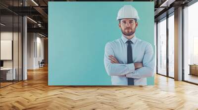 A male engineer stands with arms crossed, dressed in a formal shirt and tie, wearing a white construction helmet, ready for the next project in a professional environment Wall mural