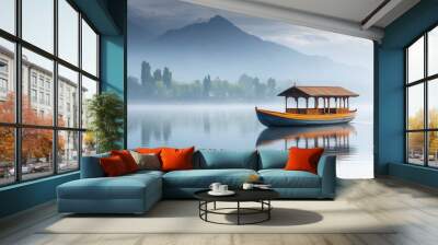 A traditional Shikara boat gently moves through the calm waters of Dal Lake, surrounded by misty mountains and lush greenery on a peaceful morning Wall mural