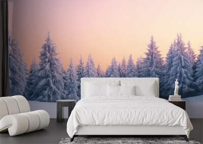 A tranquil snow-covered pine forest captures the last light of twilight, with soft orange tones illuminating the trees and winter landscape Wall mural