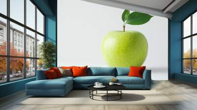 A vibrant green apple rests on a smooth surface, showcasing a single dewy leaf that enhances its freshness against a minimalistic white backdrop Wall mural