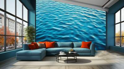 The surface of a serene water body shows gentle ripples spreading across, creating a beautiful interplay of light and water. The calmness evokes peace and tranquility Wall mural