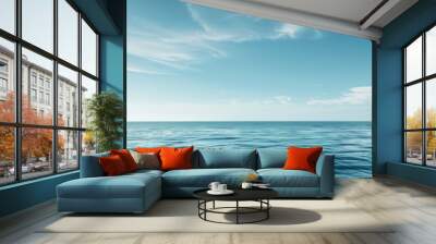 The vast expanse of the ocean stretches out before a clear blue sky dotted with wispy white clouds Wall mural