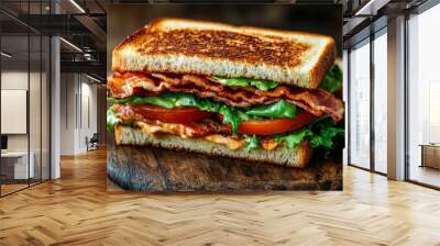 This closeup showcases a club sandwich with layers of crispy bacon, fresh greens, and ripe tomatoes, perfectly browned on toasted bread ready to be enjoyed Wall mural