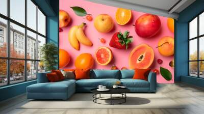 A flat lay of various fruits on a pink background. Wall mural