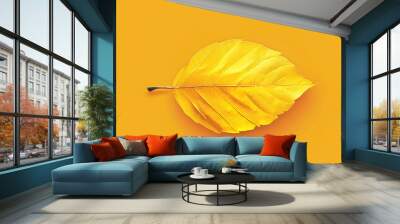 A single, bright yellow leaf against a yellow background. Wall mural