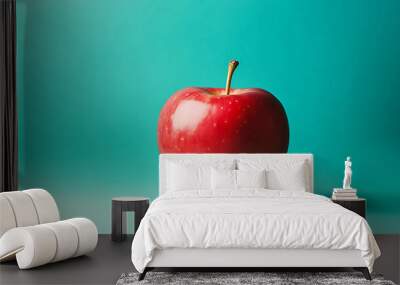 A single red apple on a turquoise background. Wall mural