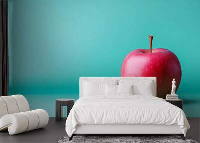 A single red apple sits on a teal background. Wall mural