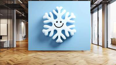 A smiling 3D snowflake on a blue background. Wall mural