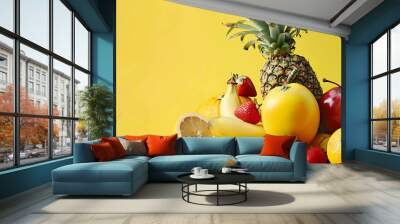 A variety of fresh fruits on a yellow background. Wall mural