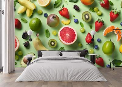 A vibrant and colorful pattern of various fruits and berries arranged on a green background. Wall mural