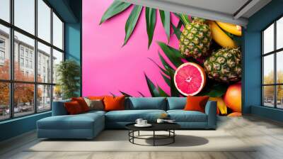 An arrangement of tropical fruits including pineapple, bananas, papaya, grapefruit, and mango on a solid pink background with green palm leaves. Wall mural