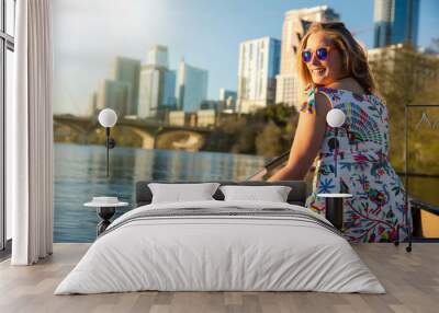 A beautiful woman in a canoe rowing on Colorado river lake, happy, joyful in Austin Texas in America Wall mural