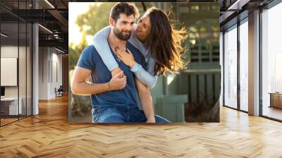 Beautiful engaged couple fiance hug and kiss good mood outside Wall mural