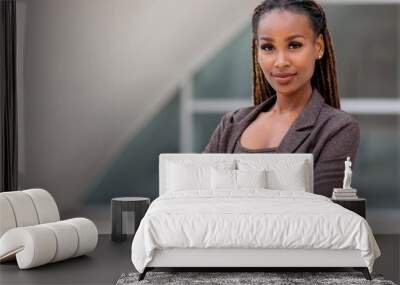 Beautiful female african american business woman CEO in a suit at the workplace, standing confidently with arms folded Wall mural