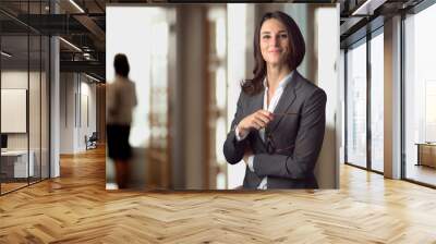 Candid portrait of a joyful cheerful happy employee staff member leader at the office workspace Wall mural