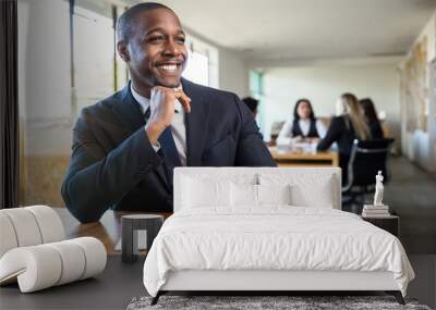 Cheerful African American businessman listening and learning at team meeting new job Wall mural