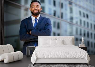 Confident successful african american businessman standing with arms folded, smiling, downtown financial district Wall mural