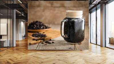 Dark rich beautiful froth foam nitro black coffee in a glass jar java Wall mural