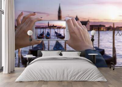 First person perspective point of view hands holding smartphone capturing footage of holiday travels in europe  Wall mural