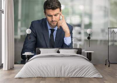 Focused businessman thinking and writing outside office Wall mural