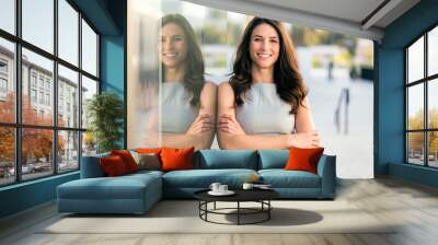 Natural happy smiling american woman in city urban environment casually standing glass reflection Wall mural