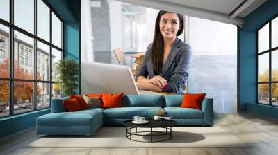 portrait of attractive business woman outside the office female professional sitting smiling Wall mural