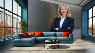 Pretty older business woman, successful confidence with arms crossed in financial building Wall mural